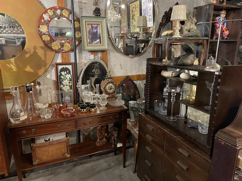 PONOPONO display of mirrors, glassware and wooden furniture